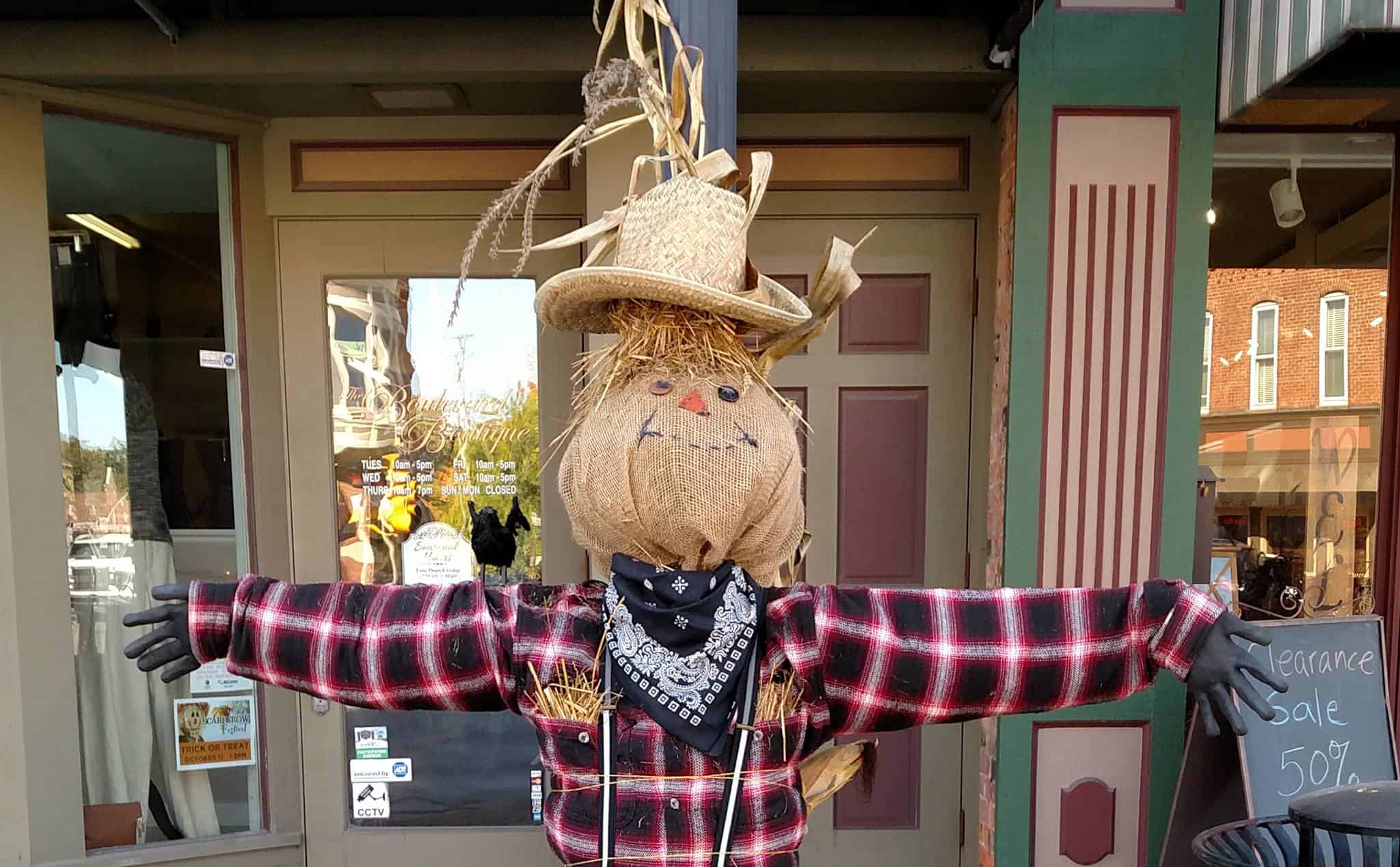 A scarecrow with his arms open wide in Downtown Oxford